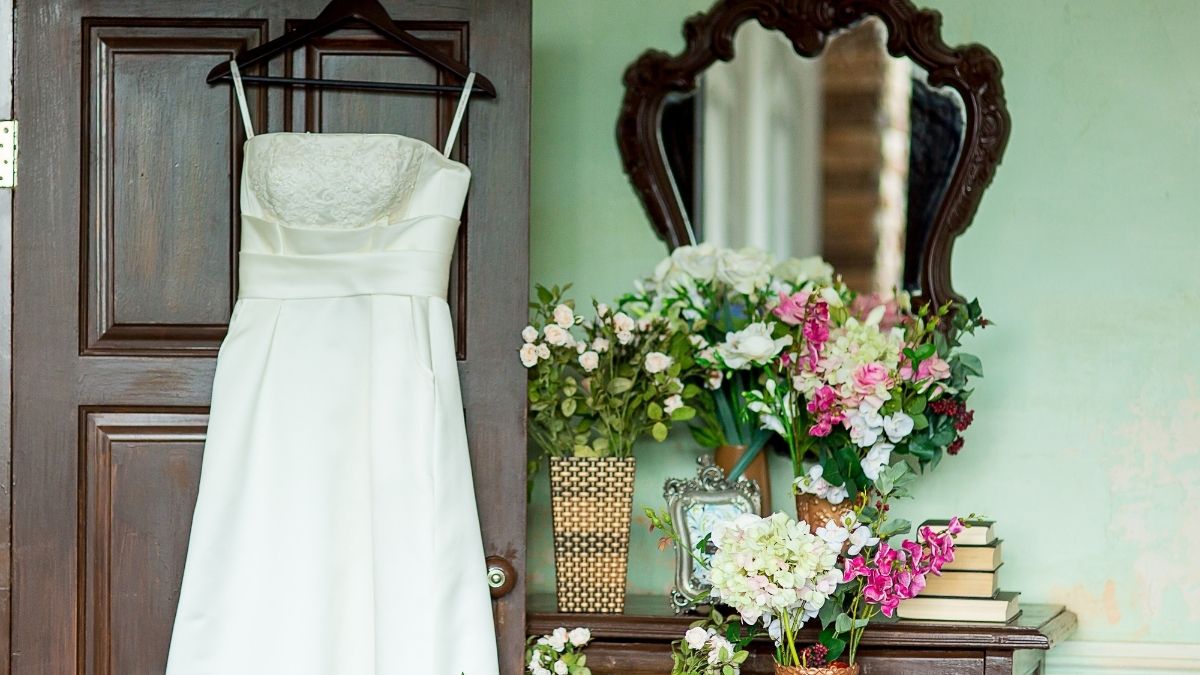a wedding dress hanged on door