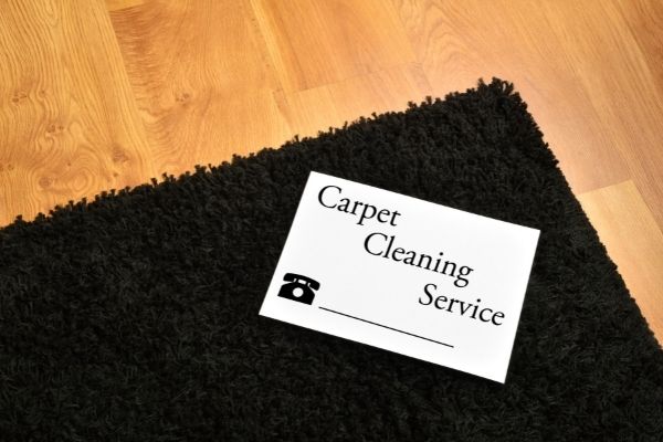Cleaning Service Card On Black Carpet