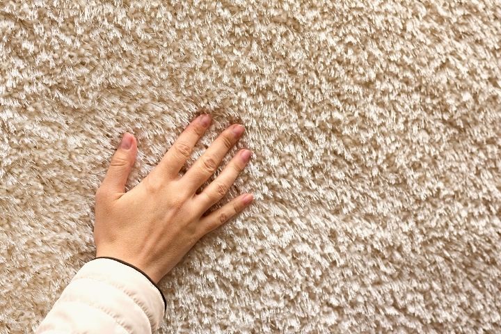 Hand On A Textured Carpet