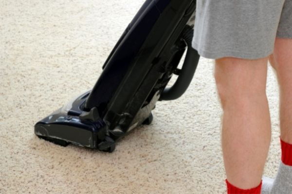 Man Vacuuming Carpet