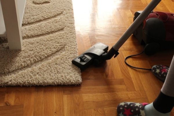 Vacuuming Carpet And Wood Floor
