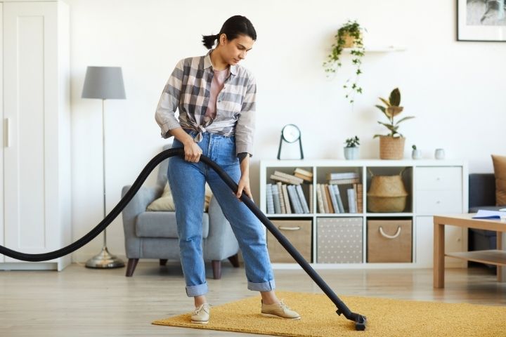 Woman Is Vacuuming A Tent Carpet