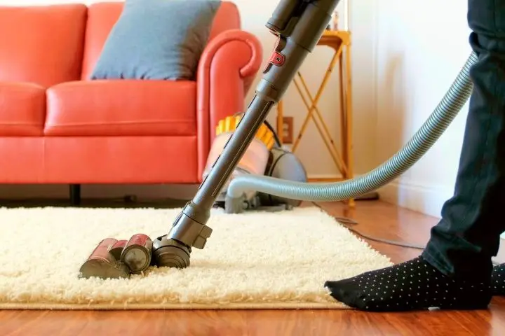 A Man Is Vacuuming A Carpet 2